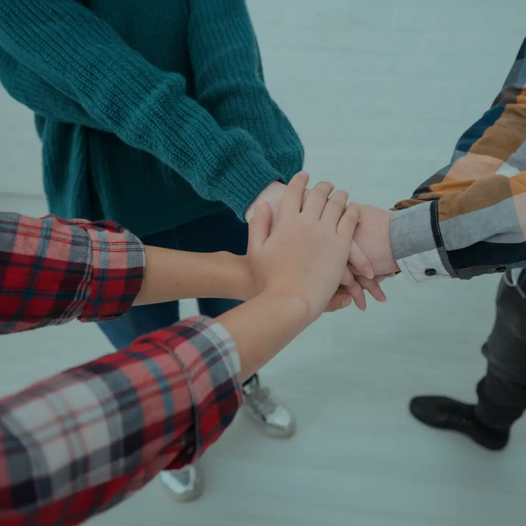 Hands joined together representing community support and donations for autism therapy at Viva The Brain in Phoenix.